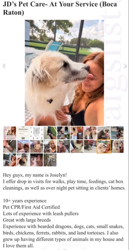 A woman with reddish hair smiles while a fluffy cream and gray dog licks her face outdoors near a pool and trees.